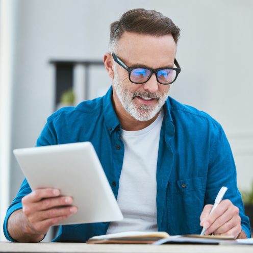 home-writing-businessman-with-tablet-planning-research-list-with-book-freelance-remote-work-mature-editor-tech-with-online-course-digital-journalism-tools-ideas